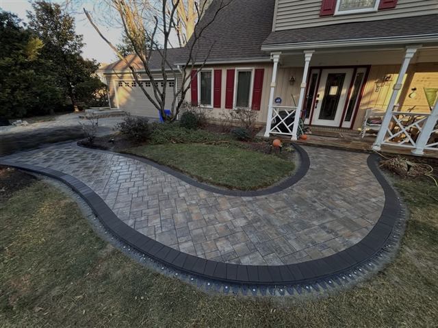 Curved paver walkway with contrasting border leading to a front porch
